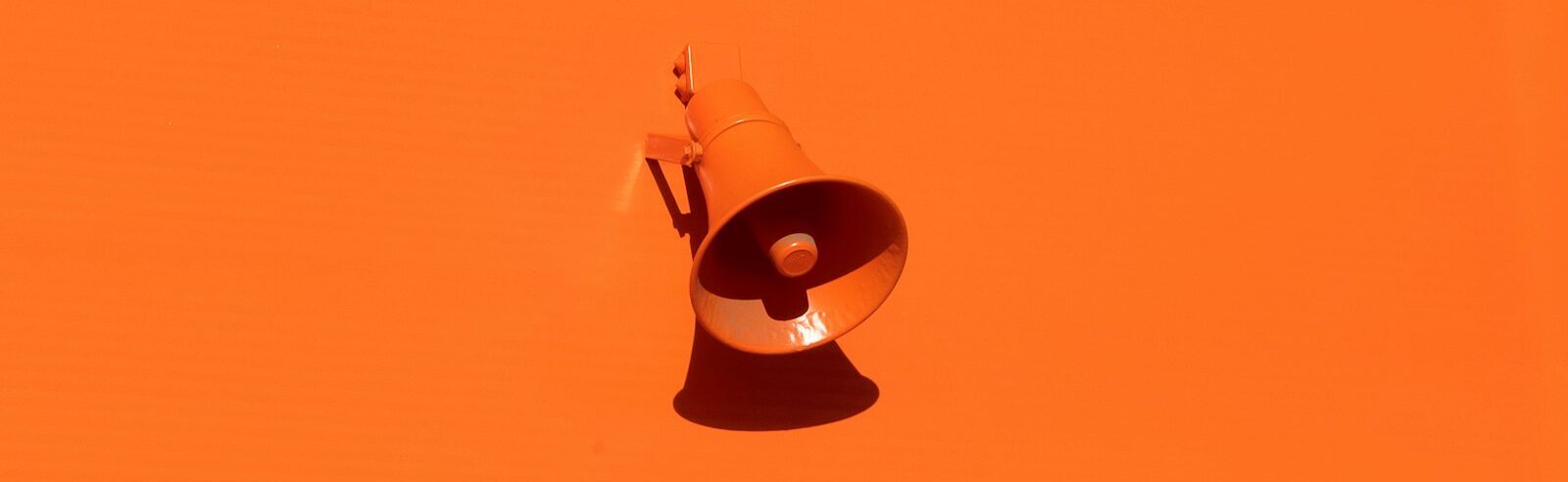 orange megaphone on orange wall